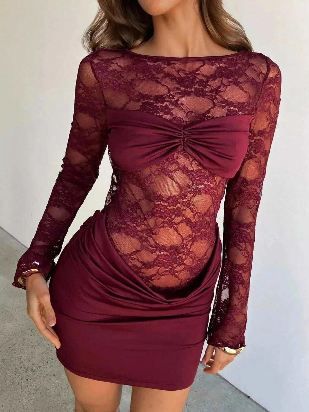 Lace Sheer burgundy bodycon dress with long lace sleeves, ruched skirt, and dramatic front bow detail