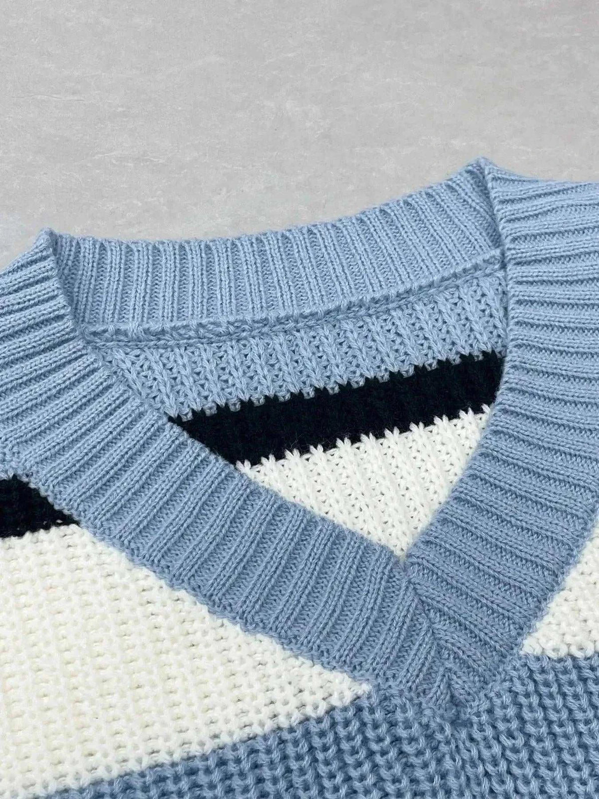 Striped V-Neck color block sweater in blue and cream knit with a black stripe and ribbed neckline