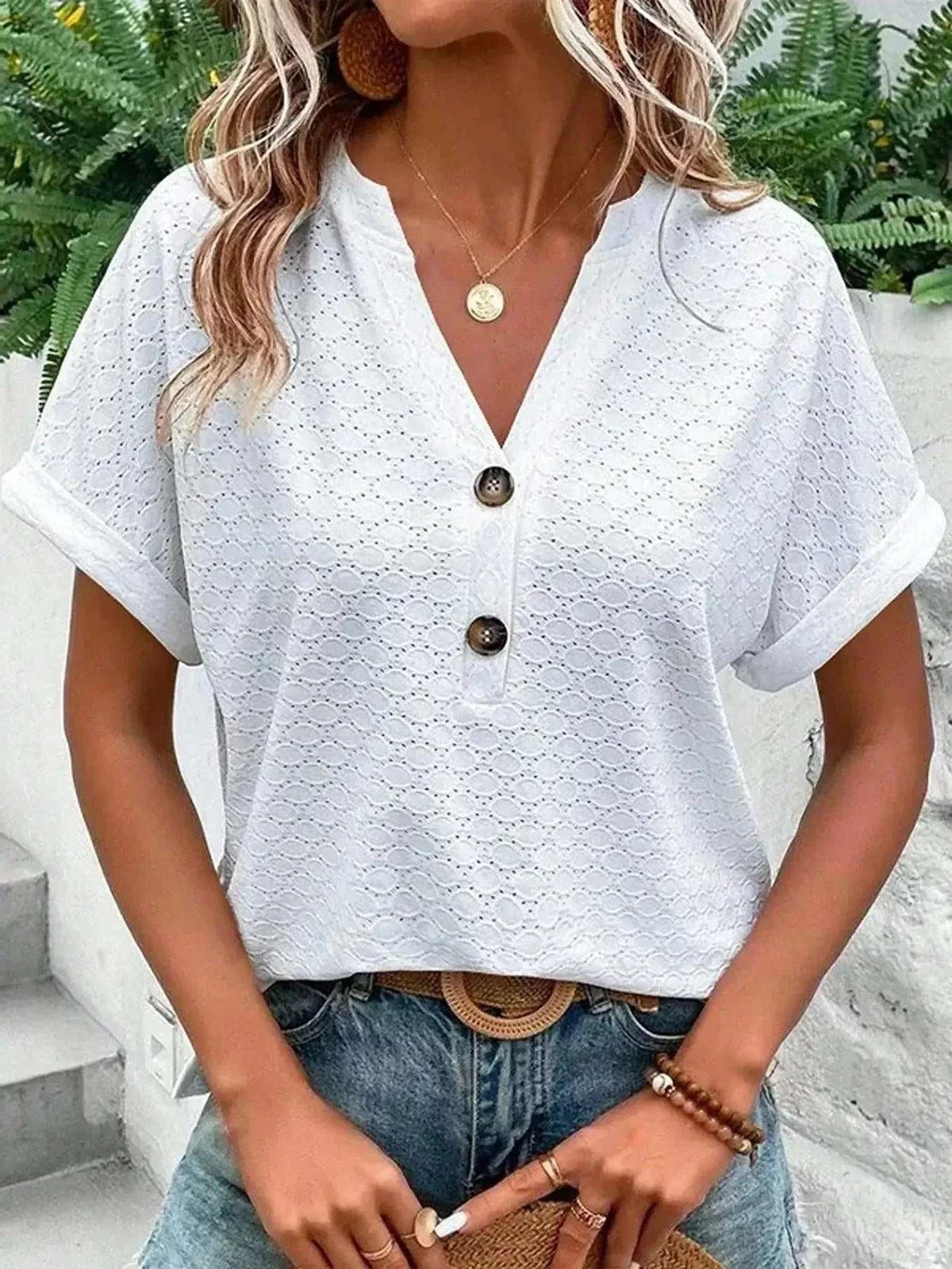 Notched Short Sleeve Top in white eyelet fabric, featuring rolled cuffs, a V-neck, and front buttons
