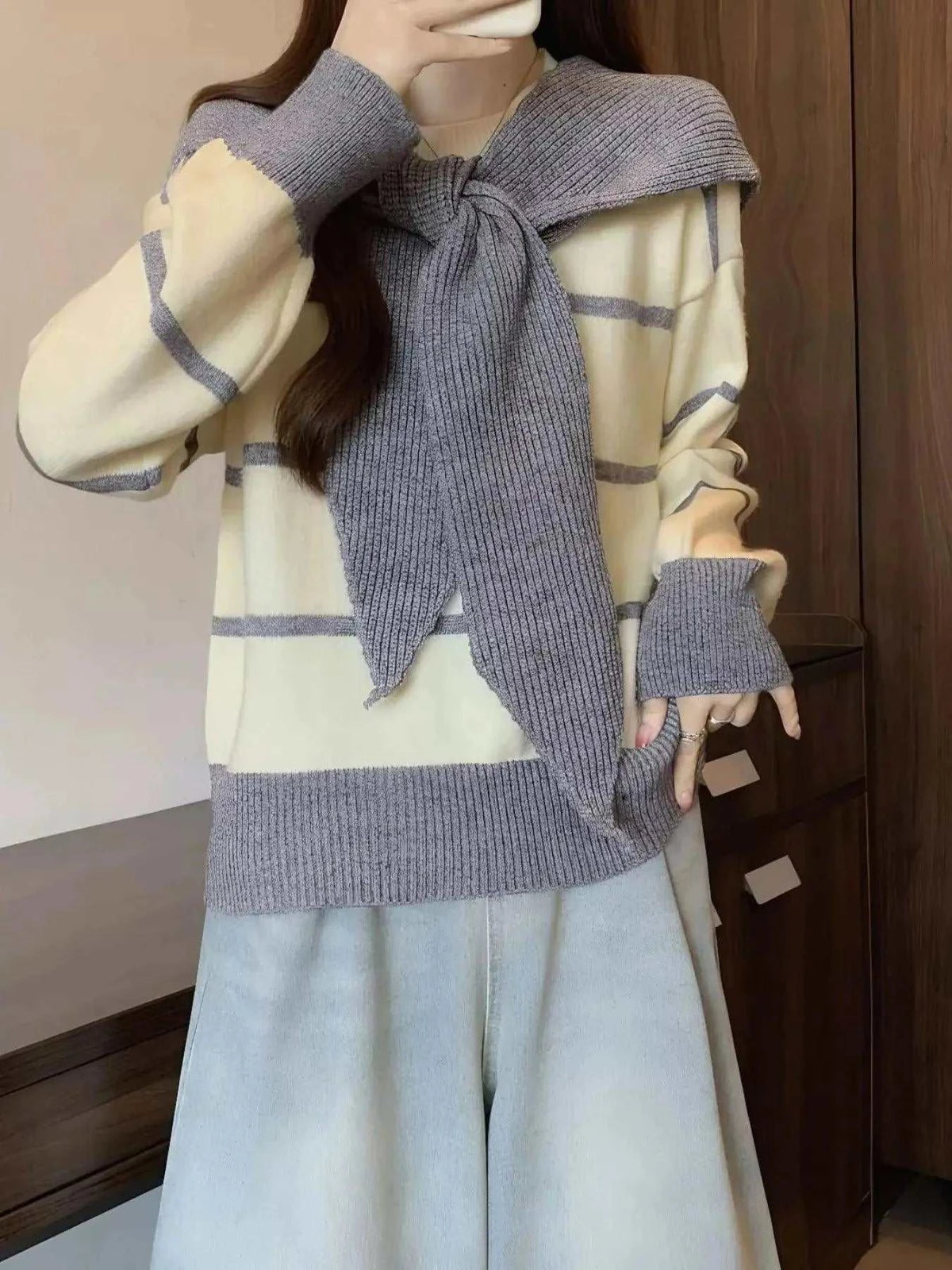 Striped Round Neck cream knit sweater with gray horizontal stripes, long sleeves, and tied scarf detail