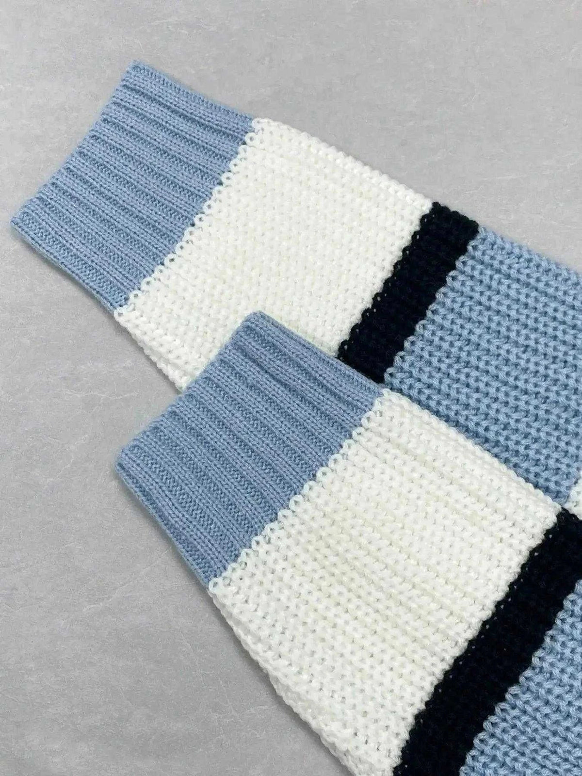 Striped V-Neck color block sweater in blue, cream, and black knit with ribbed cuffs