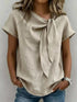 Full Size Bow Tie Neck blouse in beige textured fabric, with short sleeves and a draped front tie detail