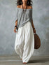 Full Size Off-Shoulder Top in gray with draped fabric, paired with flowing white wide-leg harem pants
