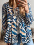 Zebra Print Tied Front blouse in blue and white patterned fabric, featuring a ruched waist and puff sleeves