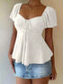 Sweetheart Neck white polyester eyelet top with ruched bust, tie-front detail, puff sleeves, and peplum hem