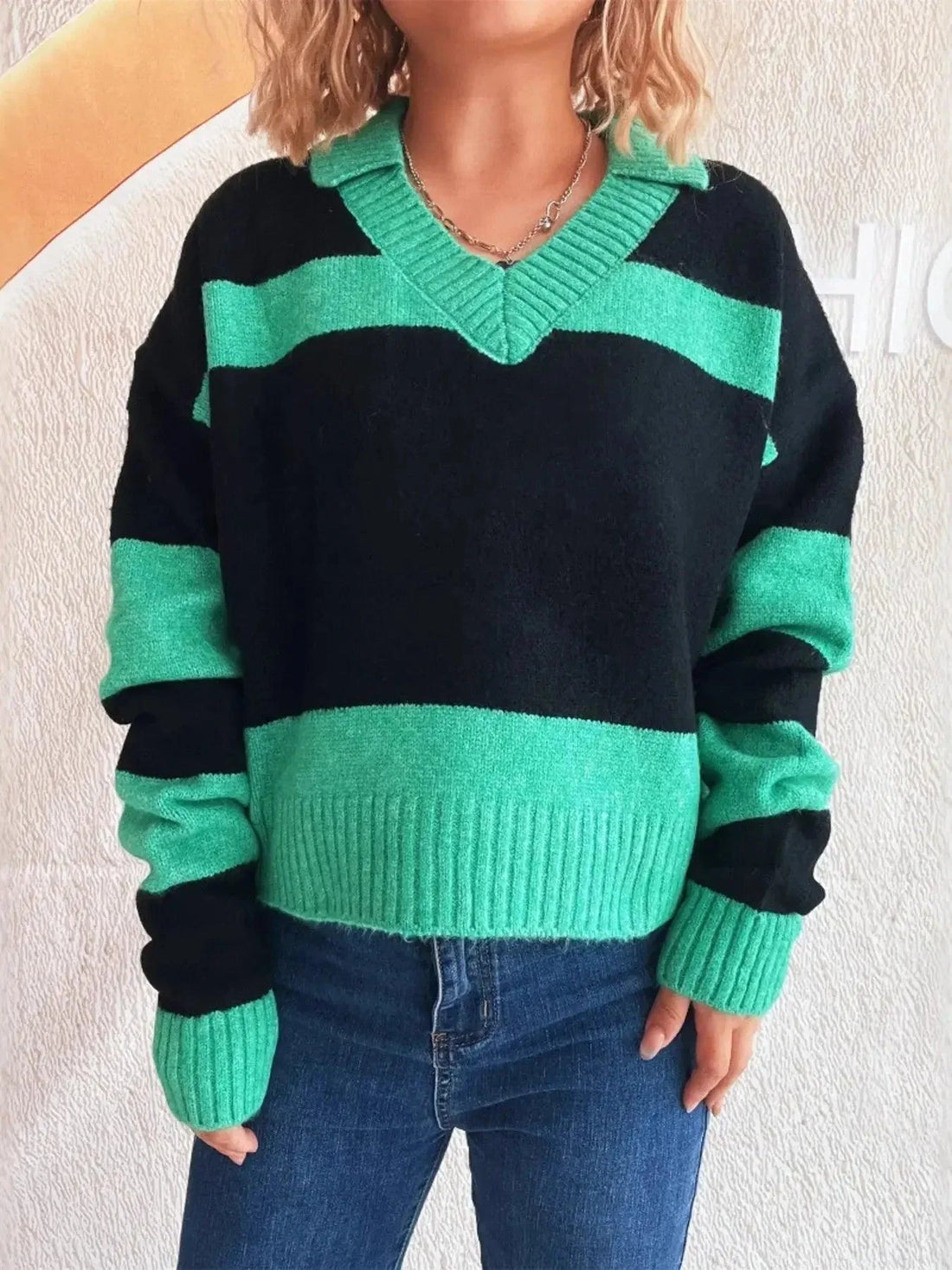 Color Block Long Sleeve Sweater in black and teal polyester with striped color-block pattern and ribbed V-neck cuffs
