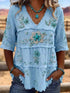 Full Size Floral light blue polyester blouse with embroidered flowers, tiered panels, V-neck, and raw hems