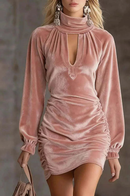 Velvet Ruched Mini Dress in blush pink velvet, featuring long sleeves, gathered sides, and a front cutout neckline