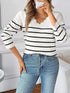 Striped V-Neck sweater in white with black horizontal stripes, ribbed trim, and long sleeves