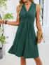 Sleeveless Twist Knot dress in dark green stretch fabric, with ruched front, sleeveless cut, and flared knee-length skirt