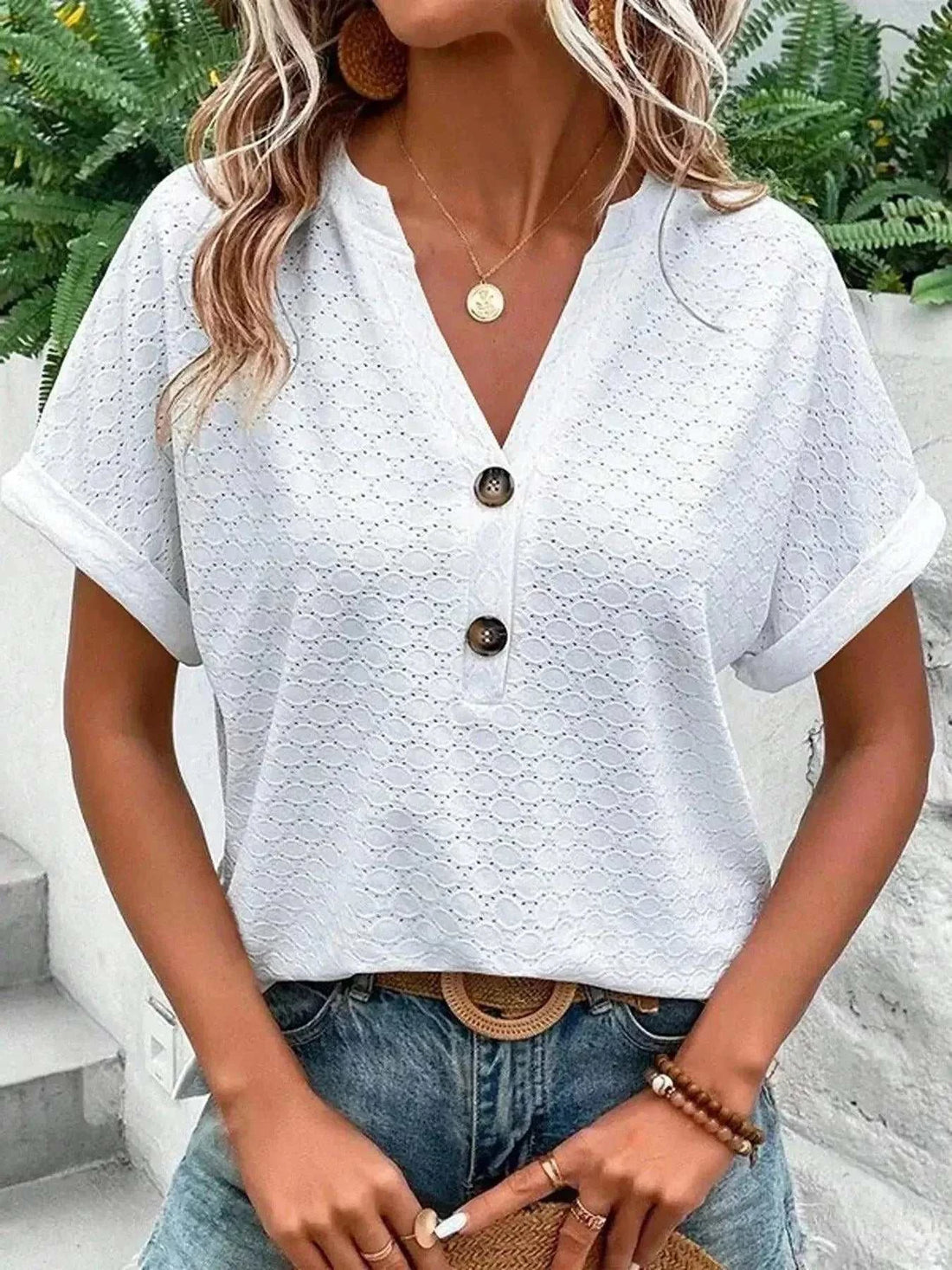 Notched Short Sleeve Top in white eyelet fabric, featuring rolled cuffs, a V-neck, and front buttons