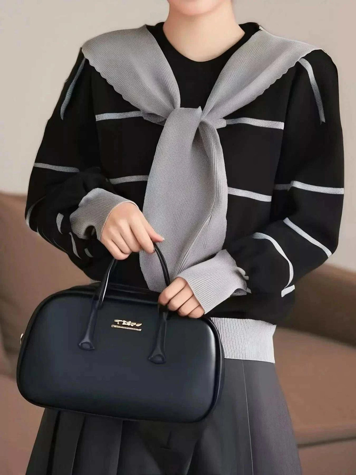 Striped Round Neck black knit sweater with gray horizontal stripes and tied gray scarf detail