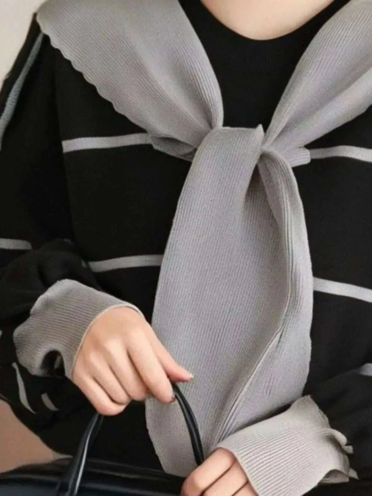 Striped Round Neck black knit sweater with gray horizontal stripes, long sleeves, and tied gray scarf detail