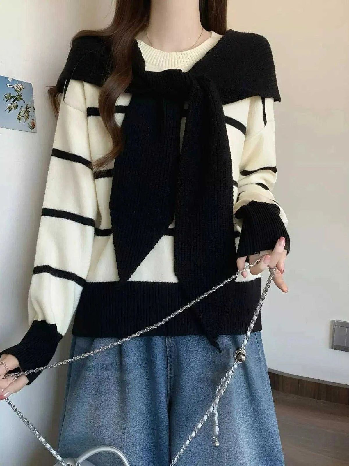 Striped Round Neck sweater in cream and black, with long sleeves, bold horizontal stripes, and a tied black knit overlay