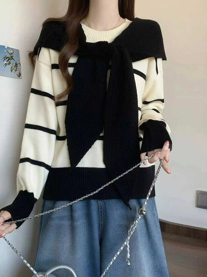 Striped Round Neck sweater in cream and black, with long sleeves, bold horizontal stripes, and a tied black knit overlay