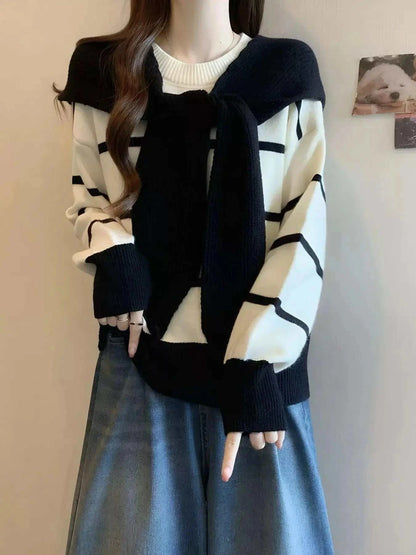 Striped Round Neck sweater in cream and navy with long sleeves, bold horizontal stripes, and tied knit detail